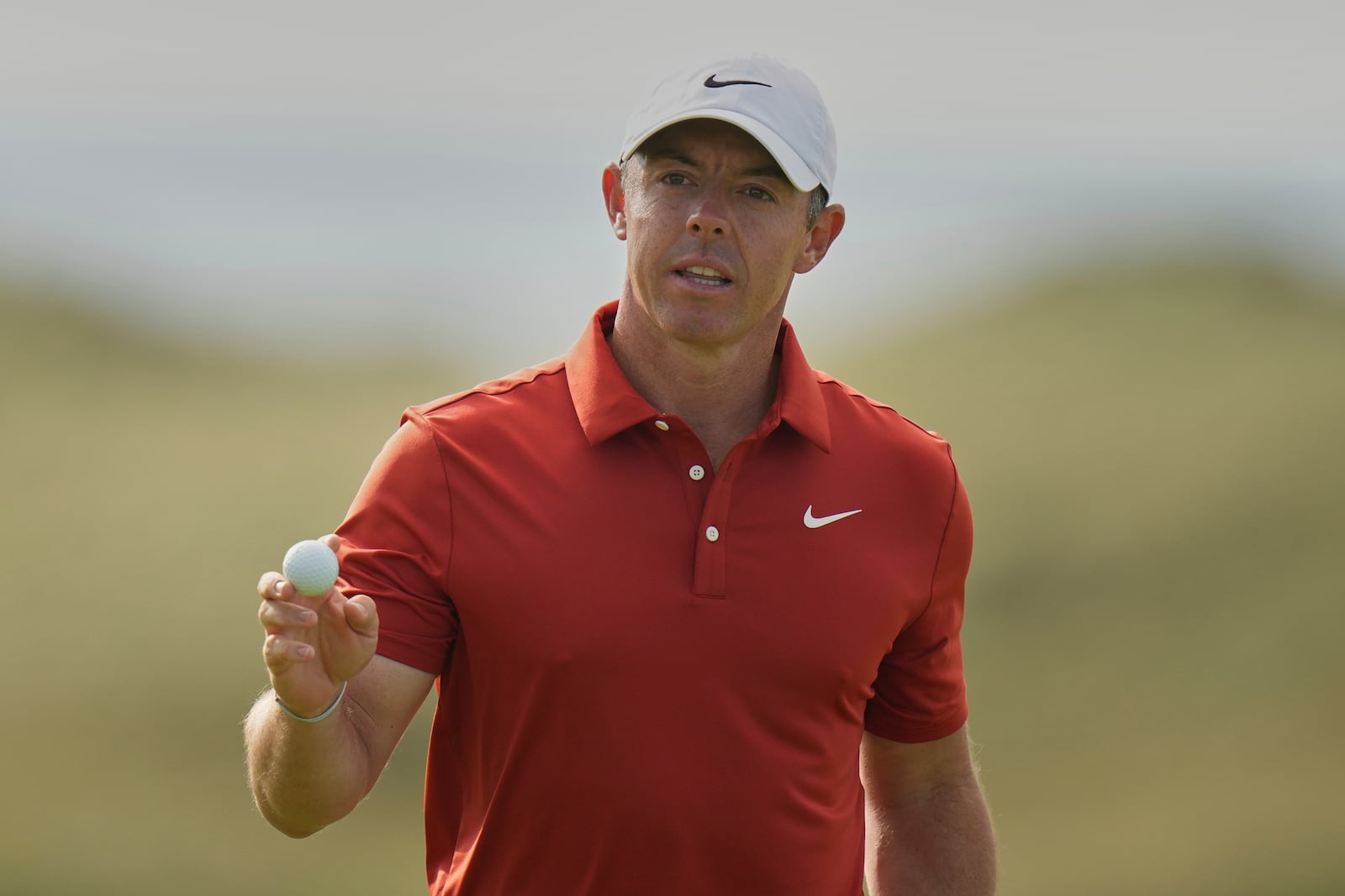 Rory McIlroy of Northern Ireland acknowledges the crowd the crowd on the 16th green during the third round of the British Open golf championship at the Royal Portrush Golf Club, Northern Ireland, Saturday, July 19, 2025. (AP Photo/Francisco Seco)