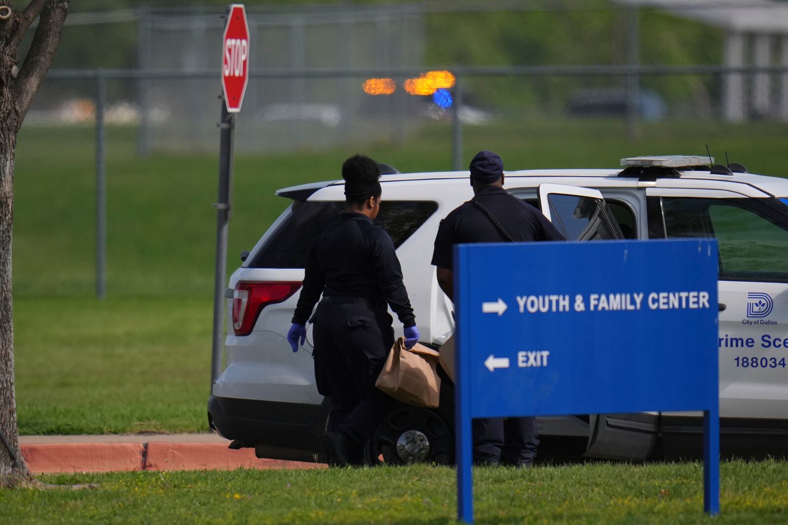 Agents load bags into a crime unit vehicle on the Wilmer-Hutchins High School grounds after authorities reported the campus had been secured following reports of a shooting, in Dallas, Tx., Tuesday, April 15, 2025. (AP Photo/Julio Cortez)