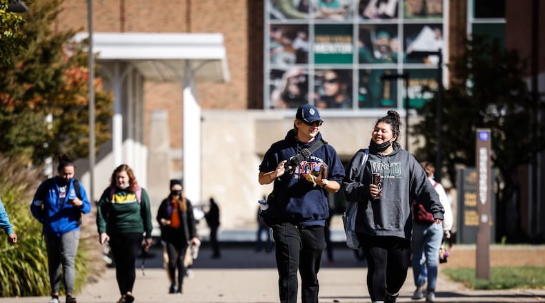 Wright State University students walk to class Tuesday Oct. 26, 2021. Wright State is giving about $6.7 million in emergency financial aid grants to students currently enrolled at the university. JIM NOELKER/STAFF