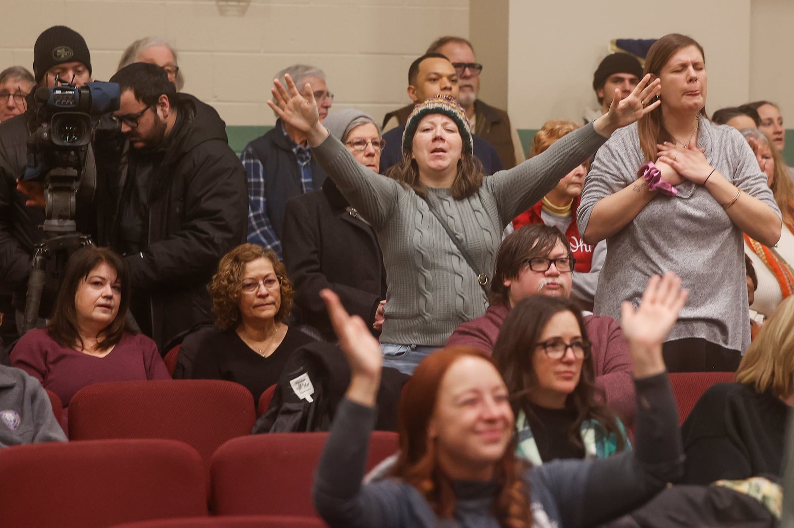 Audience members sing along to praise songs during Here We Stand: Faith Leaders for Immigration Justice & Family Unity at St. John Missionary Baptist Church on Monday, Feb. 2, 2026, in Springfield. Pastors, faith leaders and community members gathered to pray and call for the extension of Temporary Protected Status which is scheduled to expire on Tuesday, Feb. 3, 2026. JOSEPH COOKE/STAFF
