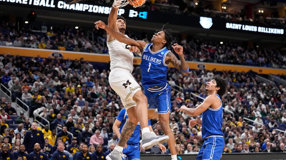 Michigan forward Yaxel Lendeborg (23) dunks over Saint Louis guard Quentin Jones (1) during the second half in the second round of the NCAA college basketball tournament, Saturday, March 21, 2026, in Buffalo, N.Y. (AP Photo/Yuki Iwamura)