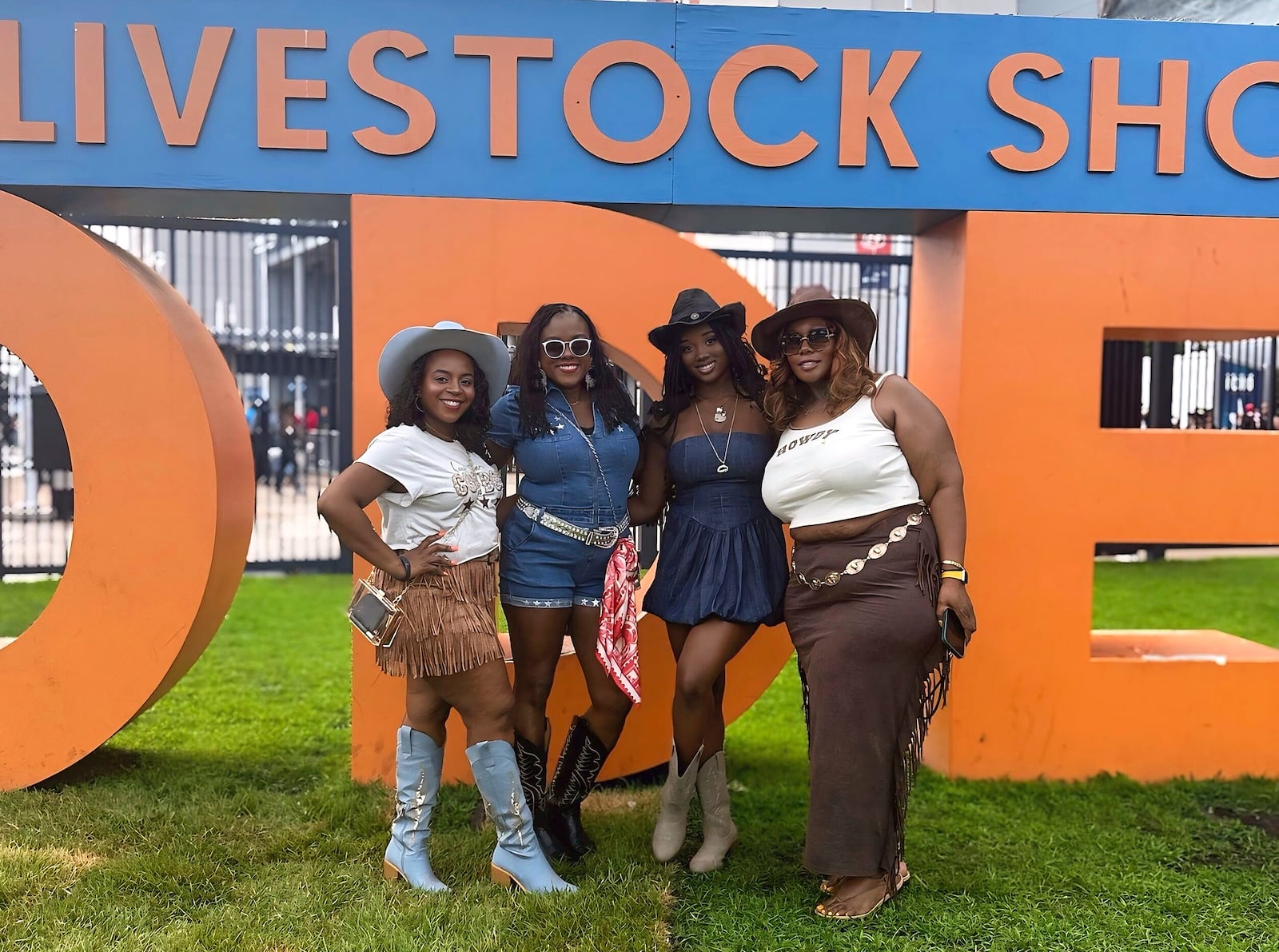 In this photo provided by Kinitra D. Brooks, standing at right, she poses for a photo dressed up for one of Beyoncé's 'Cowboy Carter' tour performances with Tia Cordier, from left, Cincia Kerr and Isabella Kerr in Houston, June 29, 2025. (Kinitra D. Brooks via AP)
