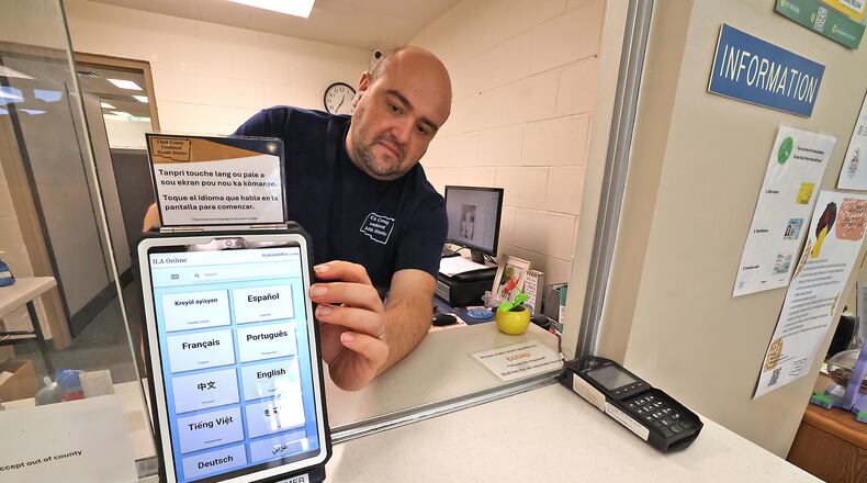File - Paden Frank, from the Clark County Combined Health District, turns on the Health District's Translate Live device at the information desk Tuesday, Aug. 27, 2024. BILL LACKEY/STAFF