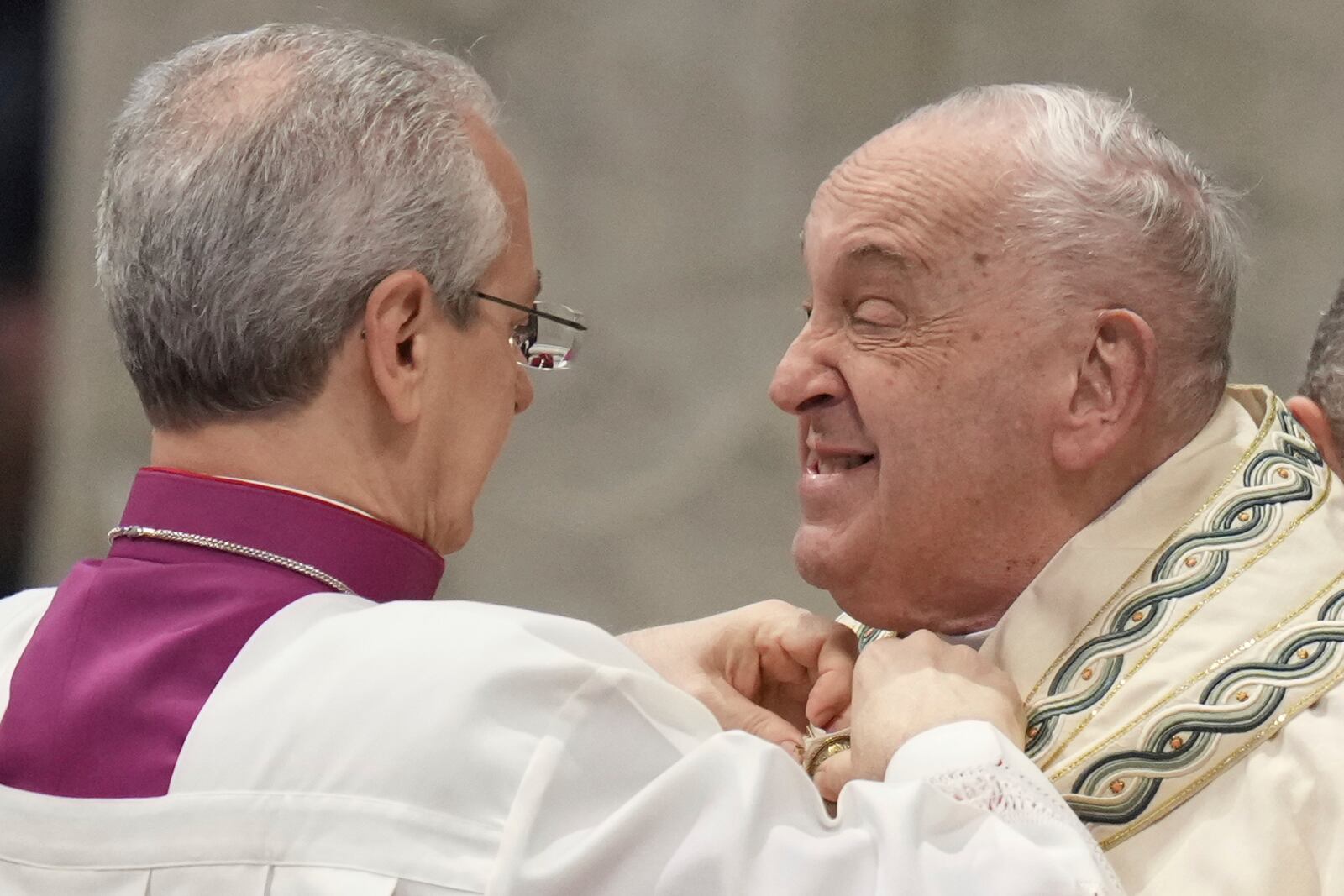 FILE - Pope Francis is helped by Vatican Master of Ceremonies, Bishop Diego Giovanni Ravelli, left, as he arrives for a mass in St. Peter's Basilica at The Vatican on New Year's Day, Wednesday, Jan. 1, 2025. (AP Photo/Andrew Medichini, File)