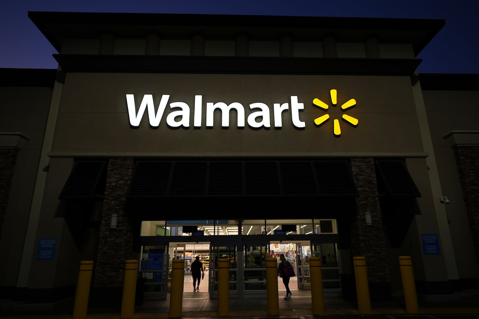 Shoppers enter a Walmart store in La Habra, Calif., Wednesday, April 9, 2025. (AP Photo/Jae C. Hong)