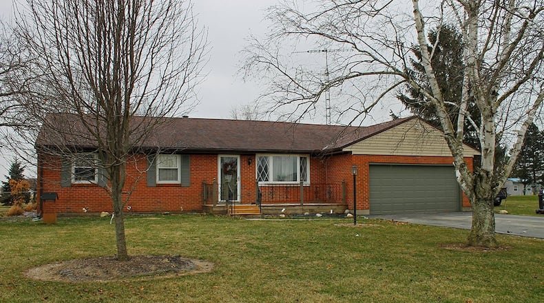 The 3-bedroom home, which has about 1,700 sq. ft. of living space, is located near the borders of Clark and Champagne counties. The home includes an outbuilding and an attached, 2-car garage. CONTRIBUTED PHOTO BY VICKIE KAPNAS