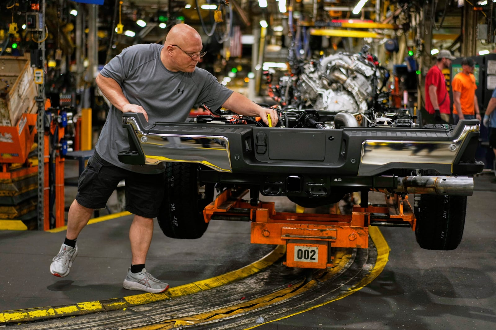 Vehicle assembly technician Kevin Zepernick works on a 2025 Ford Expedition during a media tour to launch the 2025 Ford Expedition at the Ford Motor Company Kentucky Truck Plant, Wednesday, April 30, 2025, in Louisville, Ky. (AP Photo/Carolyn Kaster)