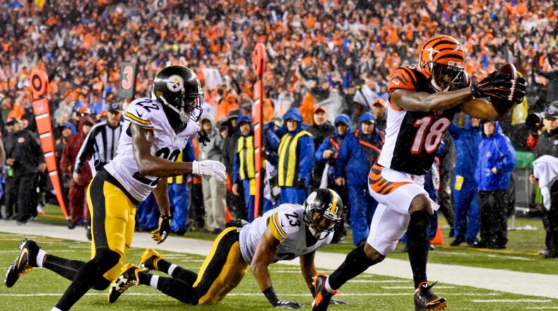 Cincinnati Bengals receiver AJ Green makes a catch and runs it in for a touchdown during their 18-16 loss to the Pittsburgh Steelers in the AFC wild card playoff game Saturday, Jan. 9 at Paul Brown Stadium in Cincinnati. NICK GRAHAM/STAFF