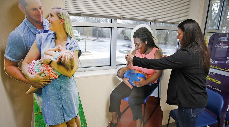 Emily Shaffer, director of the Clark County WIC program, moves some of the life-sized cut-outs of mothers as she straightens up the lobby at WIC on Thursday, Feb. 1, 2024. WIC serves roughly half of all
infants born in the U.S. through programs including supplemental food aid and health care assistance. BILL LACKEY/STAFF