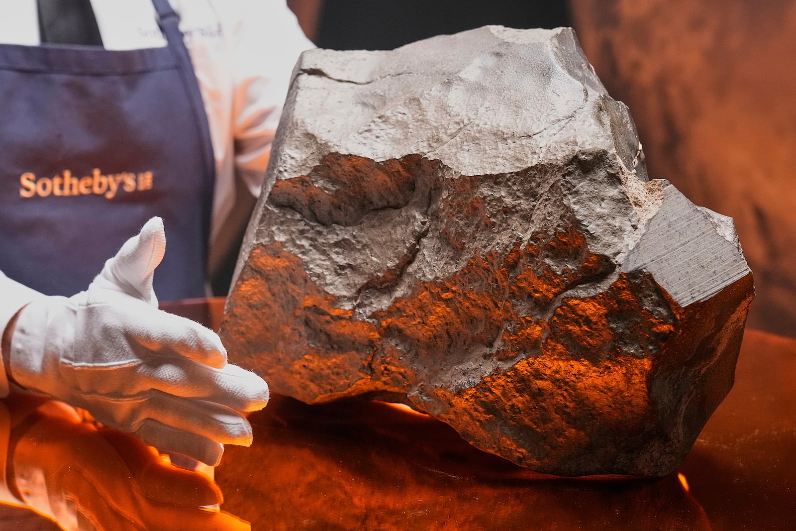 A Martian meteorite, weighing 54.388 lbs. (24.67 kg), said to be the largest piece of Mars on Earth, estimated at $2 - 4 million, is displayed at Sotheby's, in New York, Wednesday, July 9, 2025, part of their Geek Week auction, July 16, 2025. (AP Photo/Richard Drew)