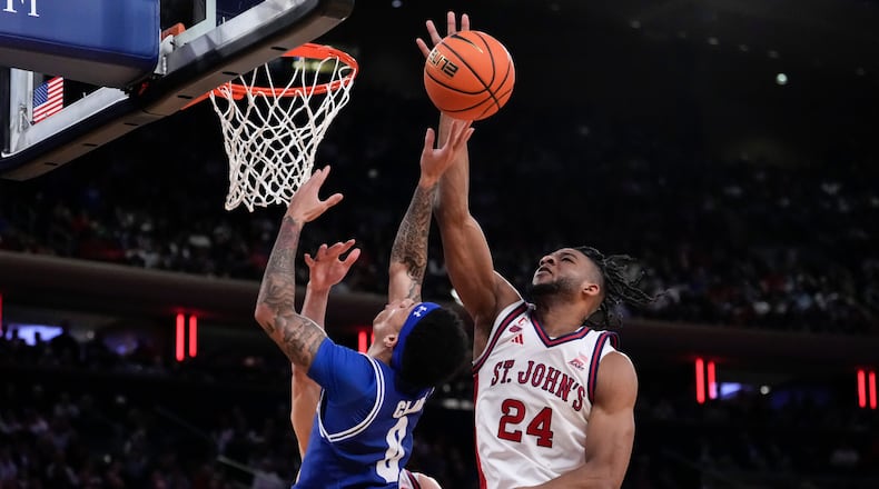 St. John's forward Zuby Ejiofor (24) blocks Seton Hall guard Adam Clark (0) during the second half of an NCAA college basketball game in the semifinals of the Big East tournament, Friday, March 13, 2026, in New York. (AP Photo/Yuki Iwamura)