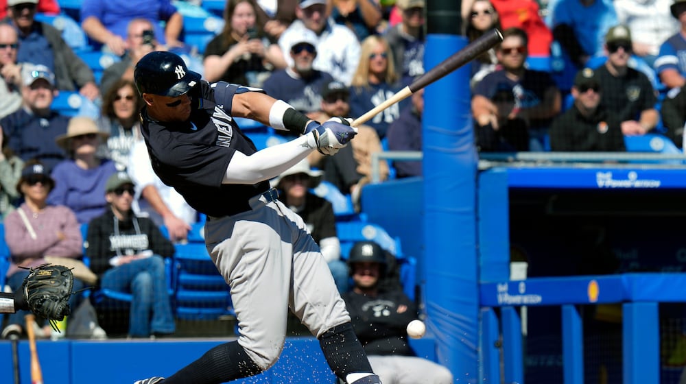 New York Yankees' Aaron Judge connects for a single off Toronto Blue Jays pitcher Jesse Hahn during the fifth inning of a spring training baseball game Tuesday, Feb. 24, 2026, in Dunedin, Fla. (AP Photo/Chris O'Meara)