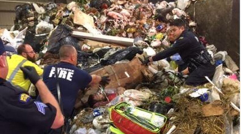 Crews at the Montgomery County Solid Waste Facility in Moraine on Tuesday morning discovered a man buried alive in garbage after a trash truck dumped its load. CONTRIBUTED
