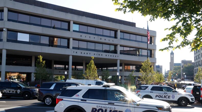 Springfield and Dayton police, along with the State Highway Patrol, search the Springfield City Hall after it was evacuated due to a threat Sept. 12, 2024. BILL LACKEY/STAFF