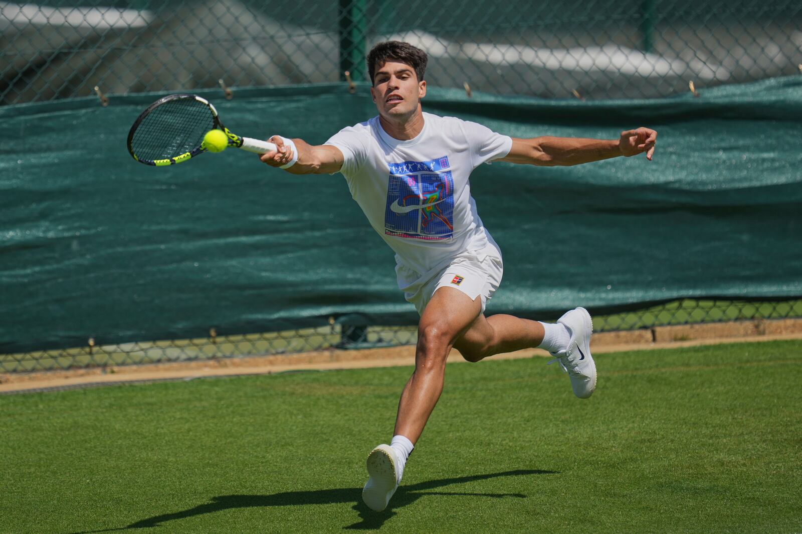 Carlos Alcaraz of Spain plays a return during a practice session ahead of the Wimbledon Championships in London, Friday, June 27, 2025. (AP Photo/Kin Cheung)
