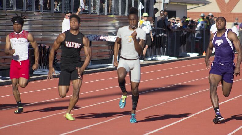 Springfield’s Quincy Scott (gray) wins the 100 meters in 10.80 seconds to edge Wayne’s Zarik Brown (10.86) at Friday’s Division I regional track and field meet at Wayne High School. Scott and Brown will compete in four events at the state meet. Jeff Gilbert/CONTRIBUTED