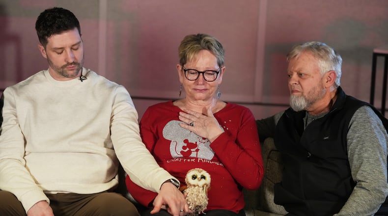 From left, Brent Ganger consoles his mother, Donna, center, and father, Tim Ganger, during an interview in Denver, on Friday, Feb. 27, 2026. (AP Photo/David Zalubowski)