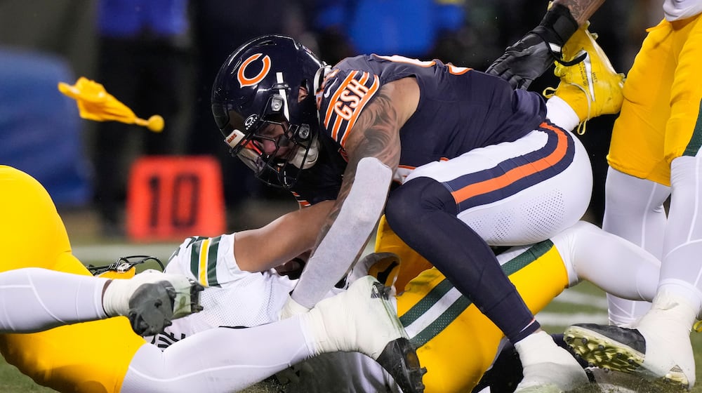 Green Bay Packers' Jordan Love is hurt as he is hit by Chicago Bears' Austin Booker during the first half of an NFL football game Saturday, Dec. 20, 2025, in Chicago. (AP Photo/Nam Huh)