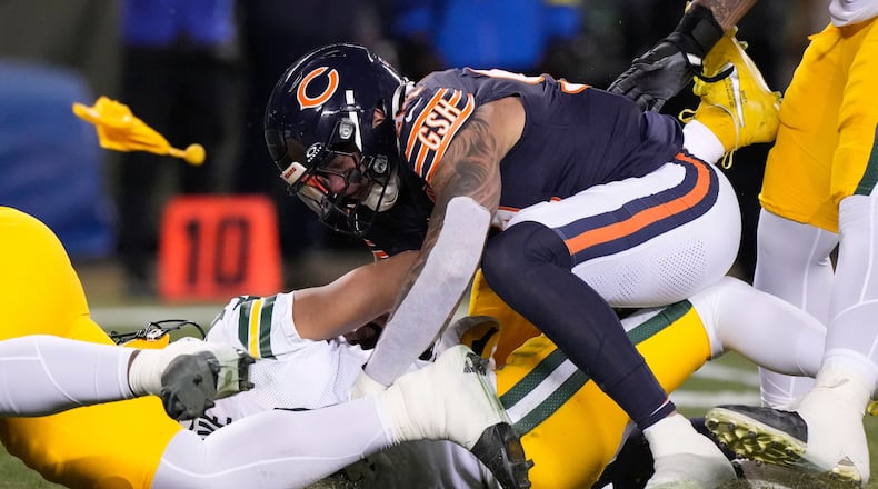 Green Bay Packers' Jordan Love is hurt as he is hit by Chicago Bears' Austin Booker during the first half of an NFL football game Saturday, Dec. 20, 2025, in Chicago. (AP Photo/Nam Huh)