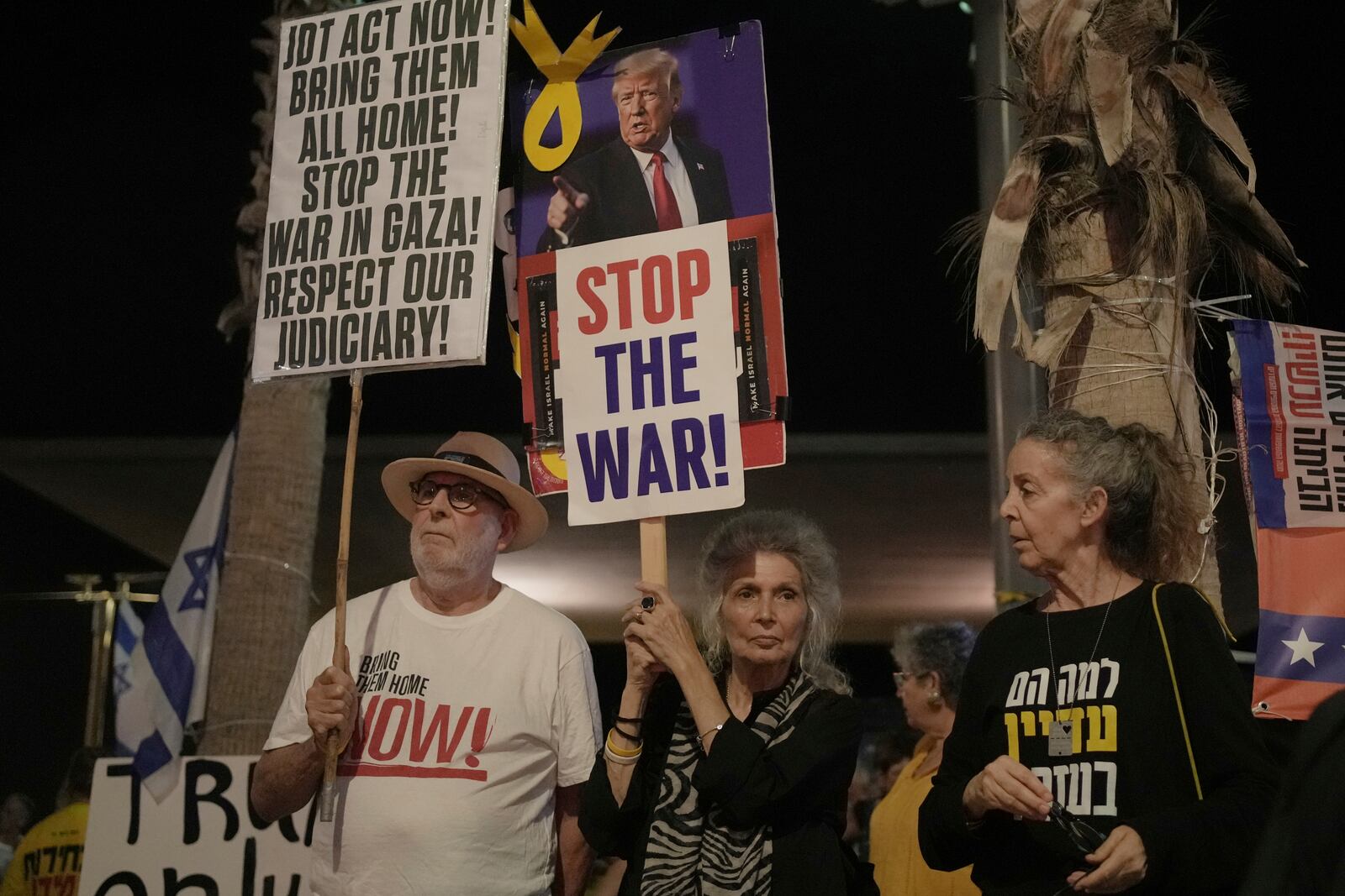 People take part in a protest outside US Embassy Branch demanding the end of the war and immediate release of hostages held by Hamas in the Gaza Strip, and against Prime Minister Benjamin Netanyahu's government in Tel Aviv, Israel, Saturday, July 19, 2025. (AP Photo/Maya Alleruzzo)