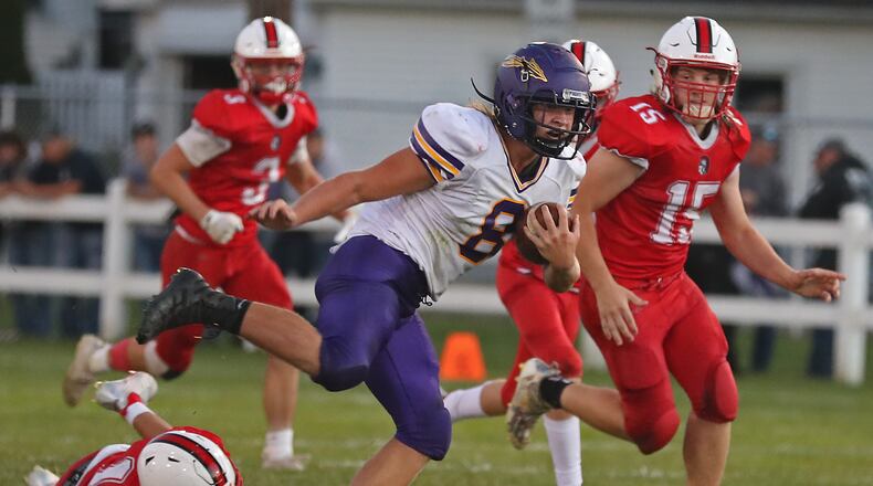 Mechanicsburg's Dylan Schetter avoids tackles as he carries the ball against Southeastern. BILL LACKEY/STAFF