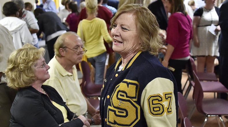 Linda Ehrle, a 1967 graduate of Springfield High School, was showing her school spirit as she toured the Springfield South building following a re-dedication ceremony Friday. Bill Lackey/Staff