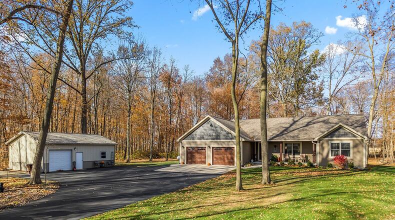 The ranch style home sits on nine plus wooded acres and has many modern updates including flooring, white cabinets and an open floorplan.