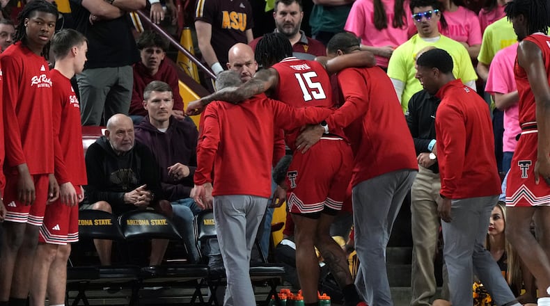 Texas Tech forward JT Toppin (15) gets helped off the court after getting injured against Arizona State during the second half of an NCAA college basketball game, Tuesday, Feb. 17, 2026, in Tempe, Ariz. Toppin did not return to the game. (AP Photo/Rick Scuteri)
