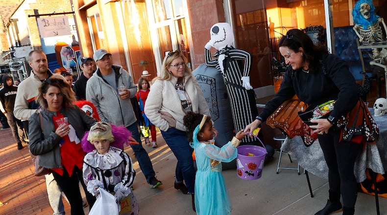Hundreds of families came out Friday night, Oct. 28, 2022 for the thrid annual Downtown Trick or Treat event in Springfield. More than 20 businesses in the downtown area, along with community groups passed out candy and goodie bags along Fountain Avenue. BILL LACKEY/STAFF