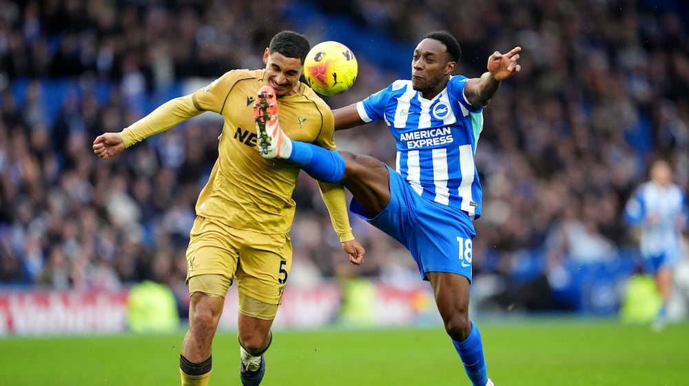 Brighton and Hove Albion's Danny Welbeck, right, and Crystal Palace's Maxence Lacroix in action during their English Premier League soccer match in Brighton, England, Sunday, Feb. 8, 2026. (Adam Davy/PA via AP)