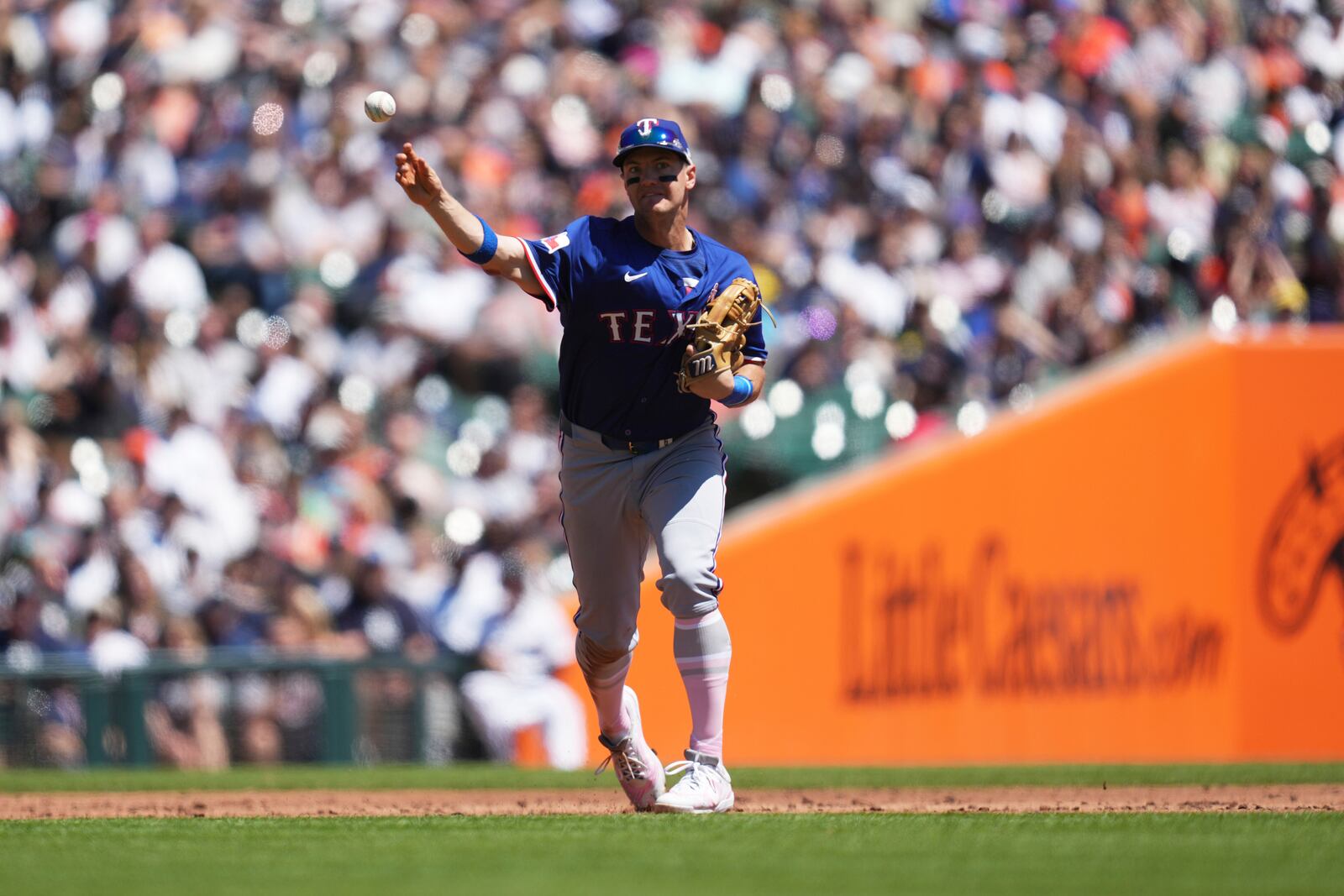 Texas Rangers third baseman Josh Jung throws to first base for an out on a Detroit Tigers' Zach McKinstry ground ball in the second inning during a baseball game, Sunday, May 11, 2025, in Detroit. (AP Photo/Paul Sancya)