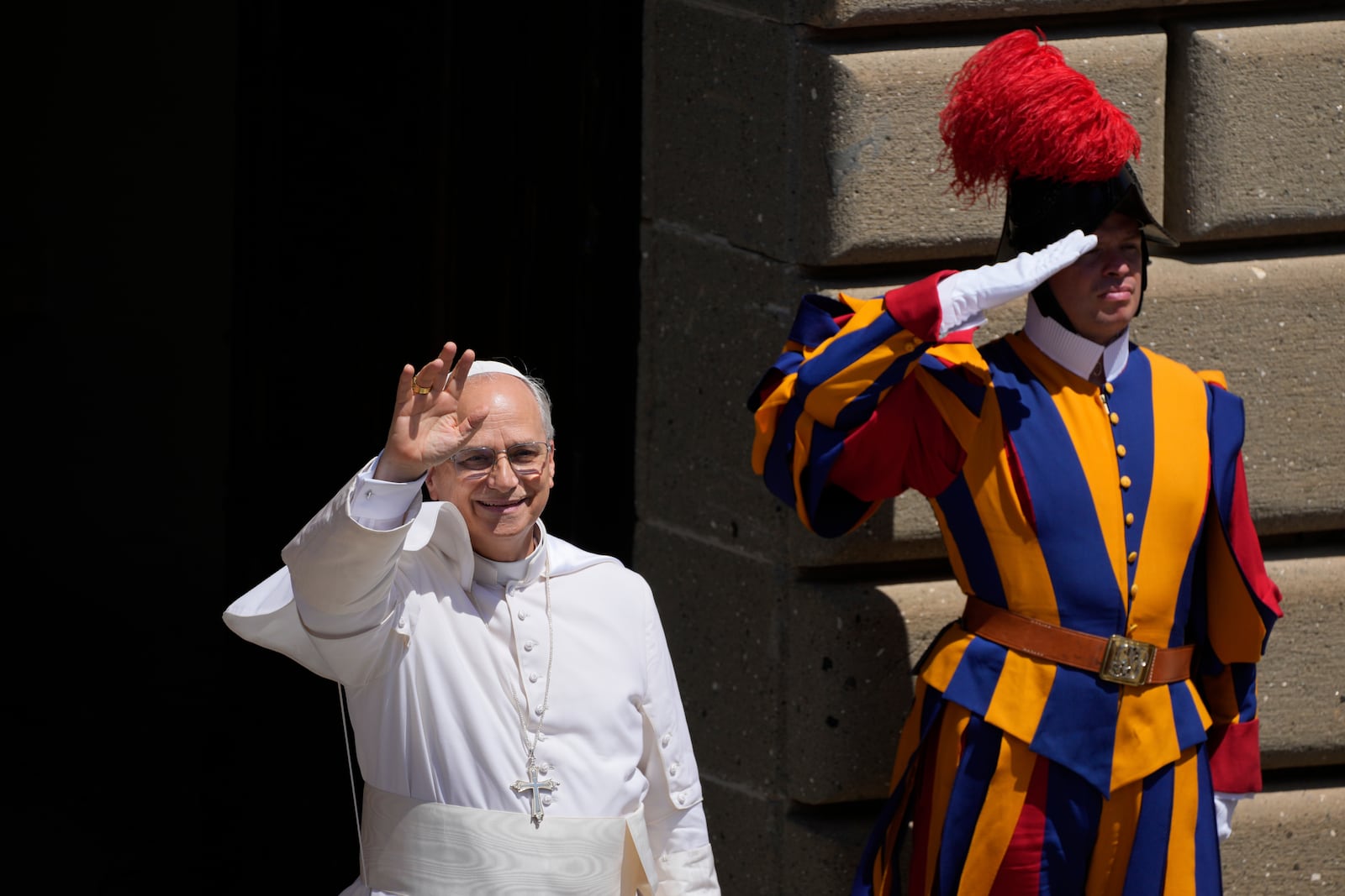 Pope Leo XIV waves to faithful at the end of the noon Angelus prayer in the square in front of the Apostolic Palace for in Castel Gandolfo, Italy, Sunday, July 20, 2025. (AP Photo/Gregorio Borgia)