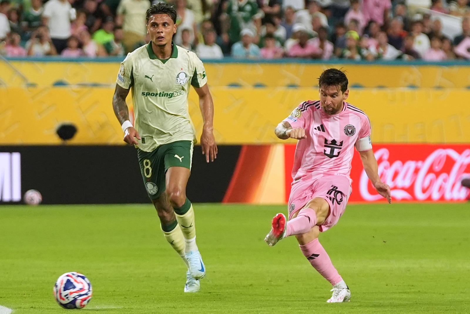 Inter Miami's Lionel Messi shoots on goal against Palmeiras' Richard Rios during the Club World Cup Group A soccer match between Inter Miami and Palmeiras in Miami Gardens, Fla., Monday, June 23, 2025. (AP Photo/Lynne Sladky)