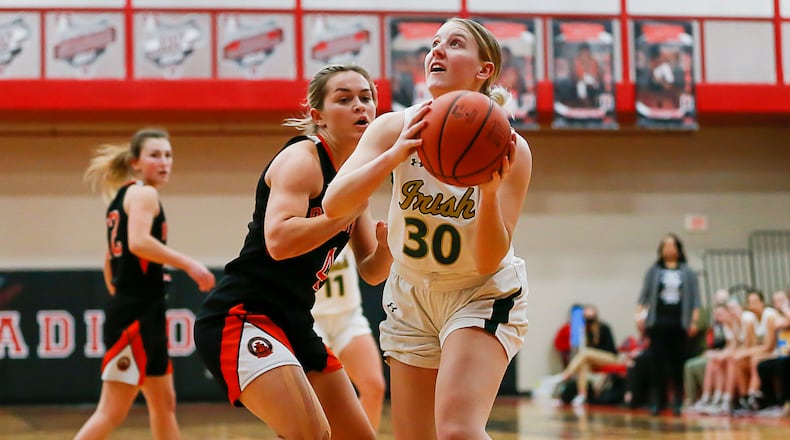 Catholic Central High School senior Serenity Castle is guarded by Bradford senior Austy Miller during their game on Tuesday night at Trotwood Madison High School. The Railroaders won 52-47 in double overtime. CONTRIBUTED PHOTO BY MICHAEL COOPER