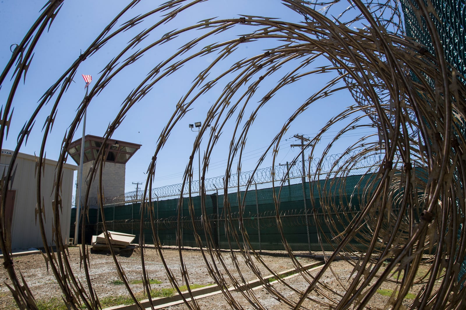FILE - In this photo, reviewed by U.S. military officials, the control tower is seen through the razor wire inside the Camp VI detention facility in Guantanamo Bay Naval Base, Cuba, April 17, 2019. (AP Photo/Alex Brandon, File)
