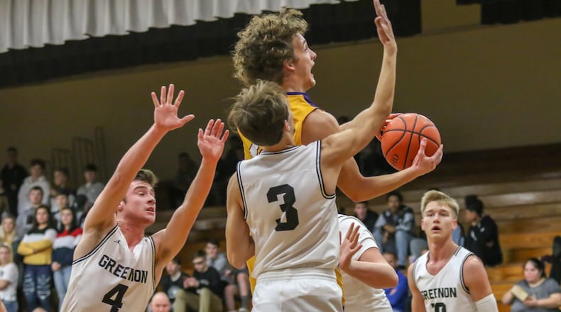 Emmanuel Christian Academy’s Casey Swank drives to the basket between four Greenon High School defenders during their game on Dec. 27. The Lions won 61-49. Michael Cooper/CONTRIBUTED