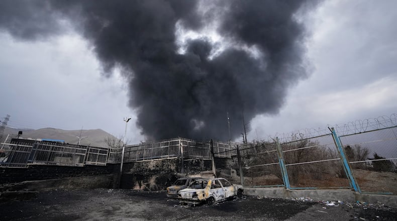 A thick plume of smoke rises from an oil storage facility hit by a U.S.-Israeli strike late Saturday in Tehran, Iran, Sunday, March 8, 2026. (AP Photo/Vahid Salemi)