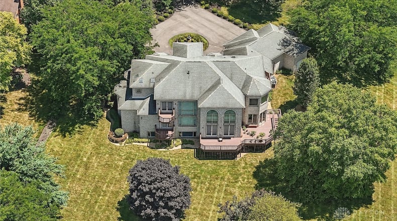 The rear of the home features three separate decks, including two private decks off bedrooms. The largest circles around to the side and has steps leading down to the backyard. Contributed