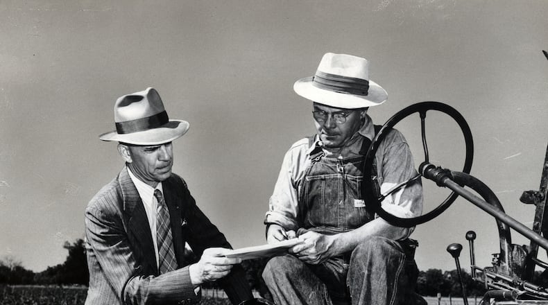 A Census enumerator assists a farmer during the 1950 Census. Photo courtesy of National Archives Catalog