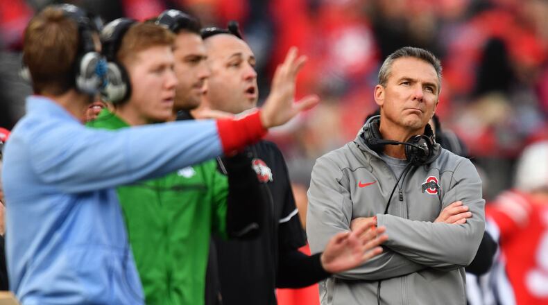 COLUMBUS, OH - NOVEMBER 11: Head Coach Urban Meyer of the Ohio State Buckeyes looks up at the scoreboard as his coaches send in plays in the fourth quarter against the Michigan State Spartans at Ohio Stadium on November 11, 2017 in Columbus, Ohio. Ohio State defeated Michigan State 48-3. (Photo by Jamie Sabau/Getty Images)