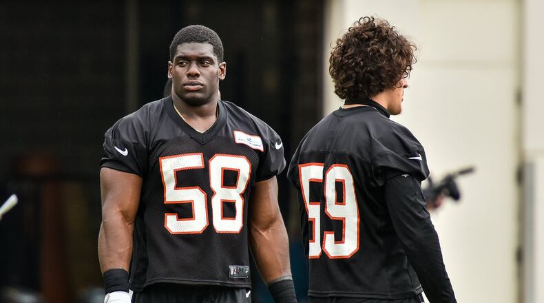 Bengals’ linebackers Carl Lawson (left) and Nick Vigil. Lawson is back from a season-ending ACL injury last year. NICK GRAHAM/STAFF