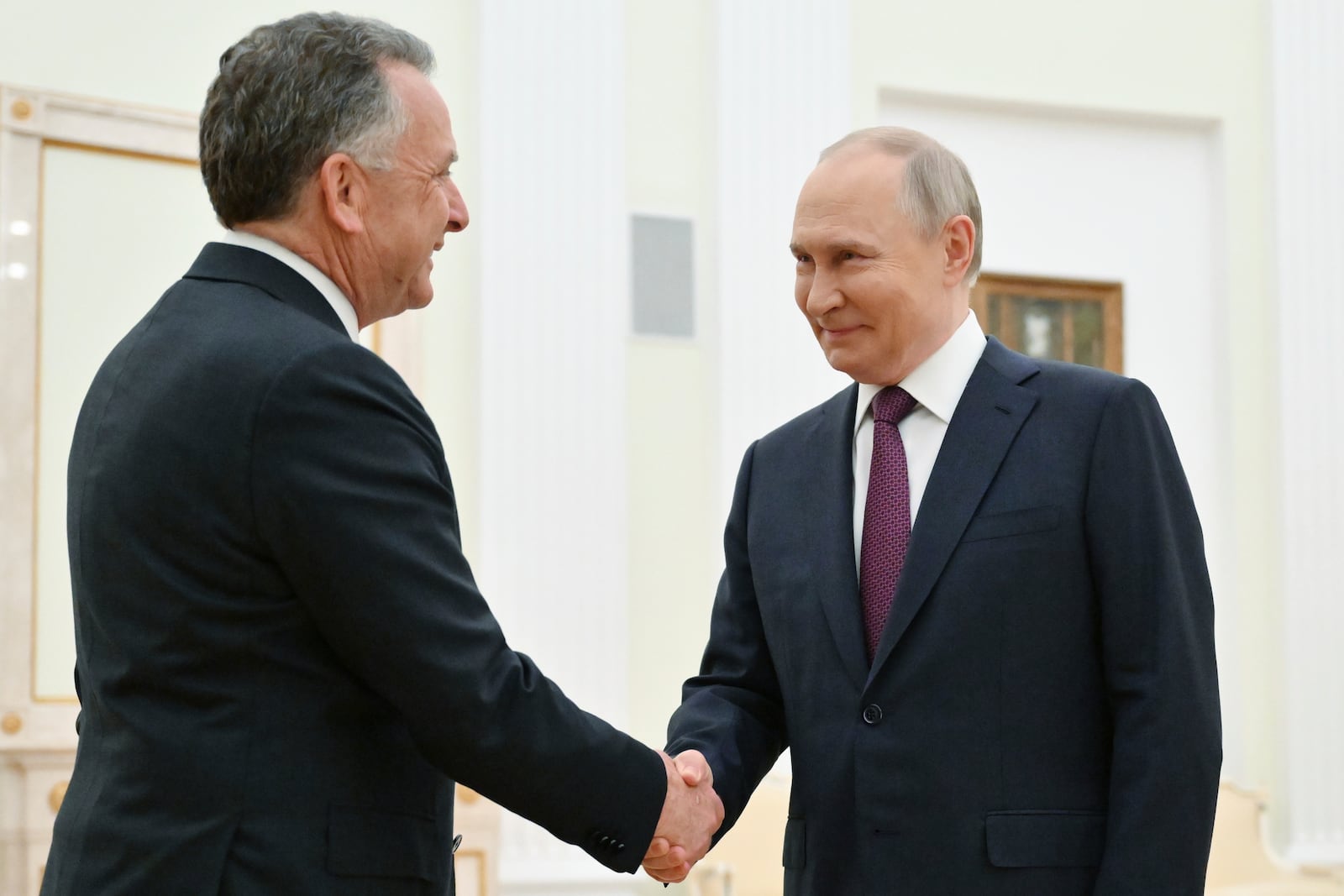 Russian President Vladimir Putin, right, and U.S. President Donald Trump's special envoy Steve Witkoff greet each other prior to their talks at the Kremlin in Moscow, Russia, Friday, April 25, 2025. (Kristina Kormilitsyna, Sputnik, Kremlin Pool Photo via AP)