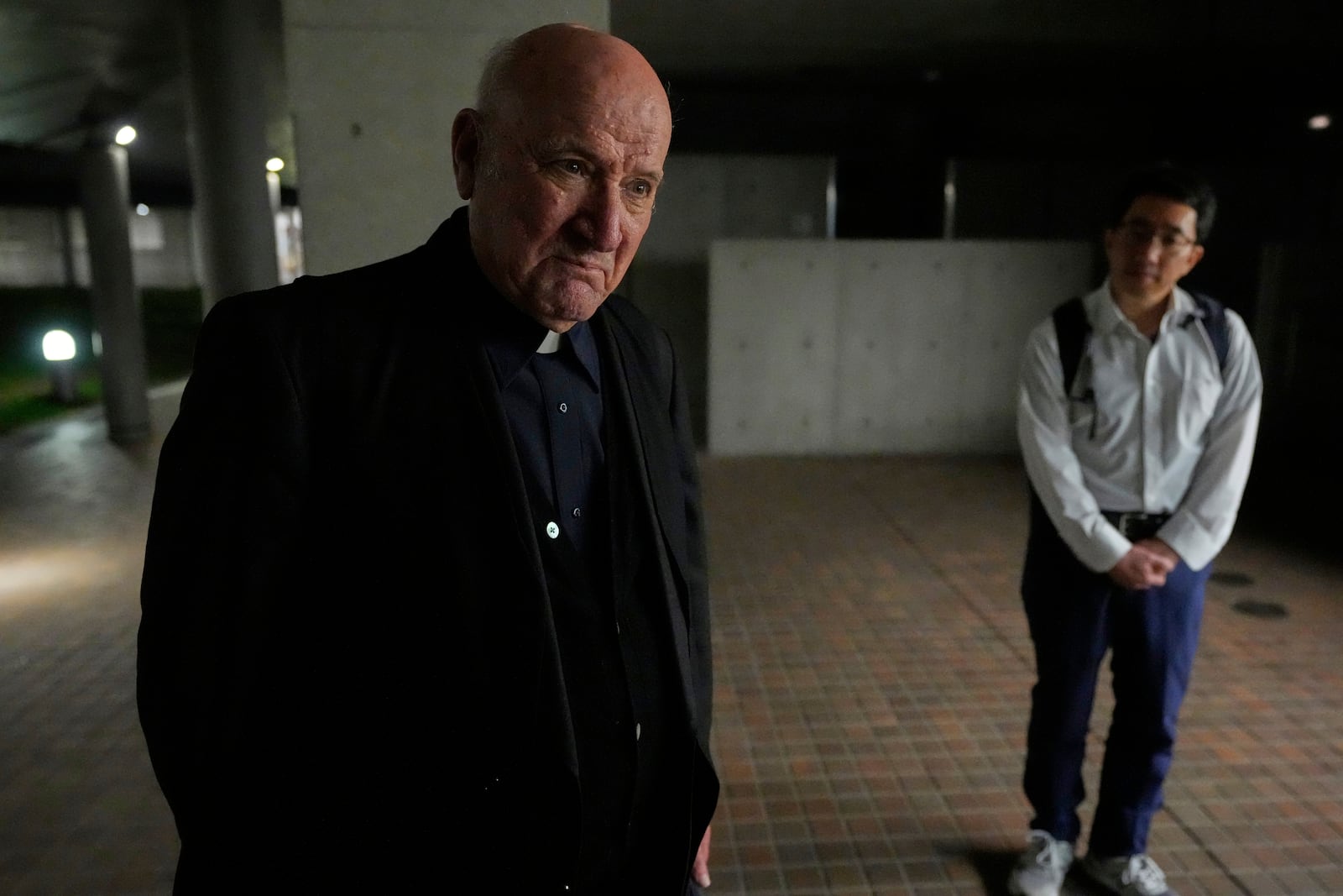 Fr. Saturnino Ochoa, left, is interviewed by a TV reporter at St.Ignatius Catholic Church in Tokyo, Japan, following the announcement by the Vatican of the death of Pope Francis, Monday, April 21, 2025. (AP Photo/Shuji Kajiyama)