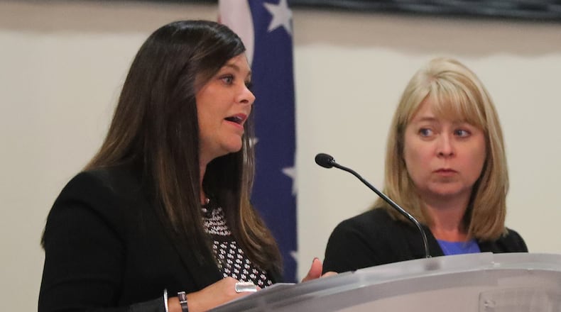 Amy Donahoe, director of Workforce Development for the Chamber of Greater Springfield, left, and Toni Overholser, director of the Clark State Foundation, speak at the Springfield Rotary Club meeting Monday. BILL LACKEY/STAFF