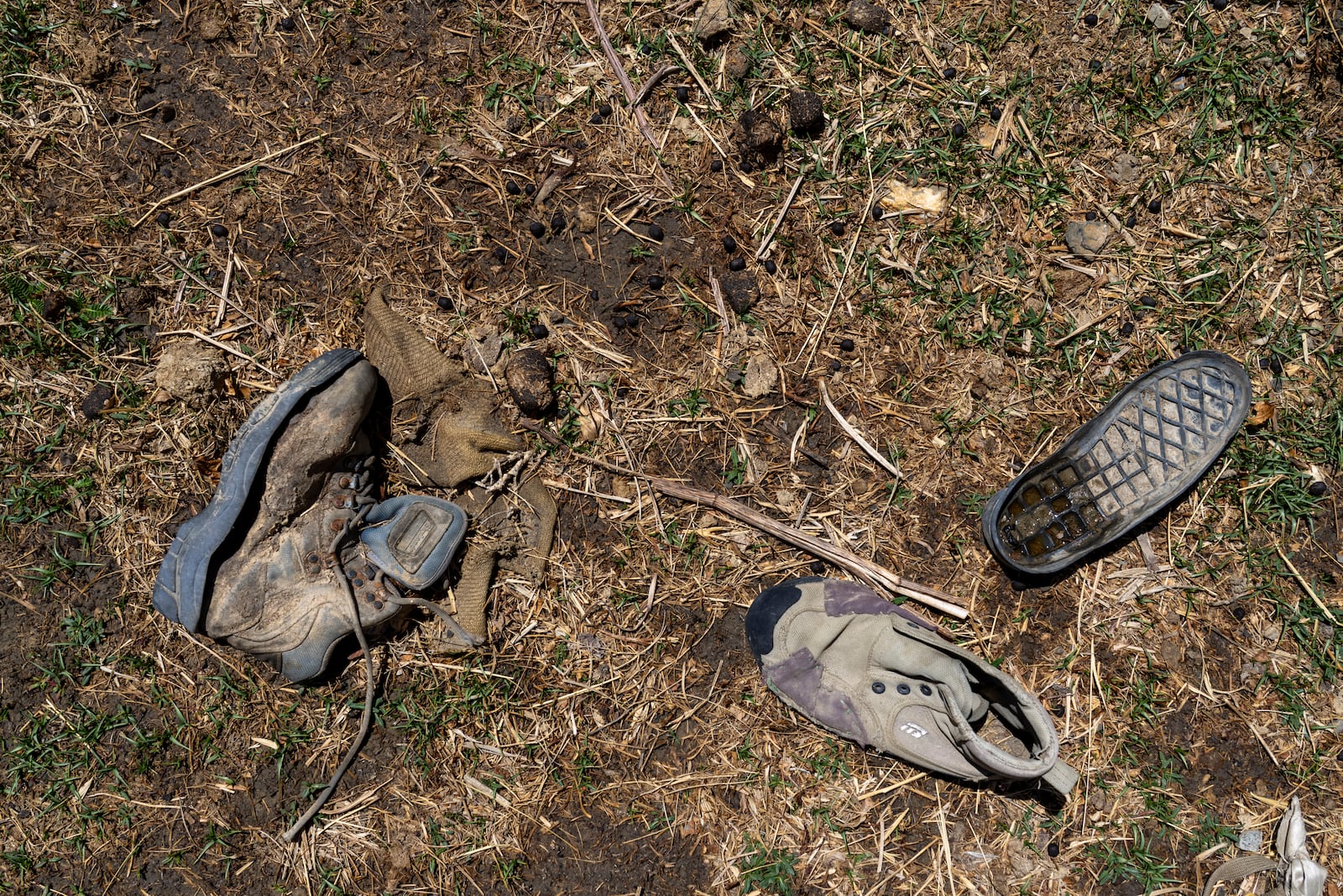 Worn out shoes are strewn in a field in the abandoned Samjung village, Mustang region, 462 kilometers (288 miles) west of Kathmandu, Nepal, Friday, April 18, 2025. (AP Photo/Niranjan Shrestha)