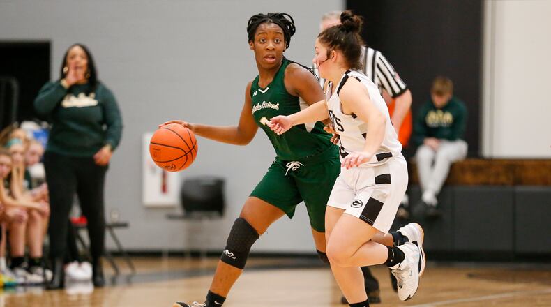 Catholic Central High School sophomore Jordyn Smoot is guarded by Greenon sophomore Allie Hundley during their game on Monday night in Enon. The Irish won 46-37. Michael Cooper/CONTRIBUTED