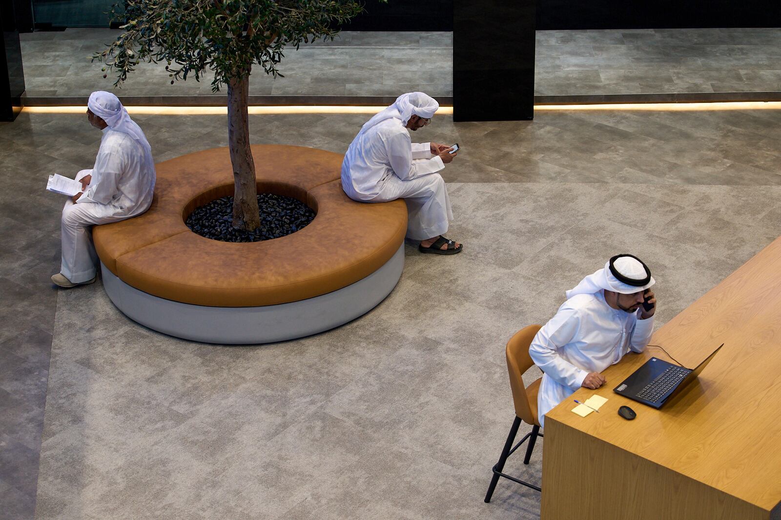 Emirati men are seen in the Dubai Financial Market in Dubai, United Arab Emirates, Monday, April 7, 2025. (AP Photos/Fatima Shbair)