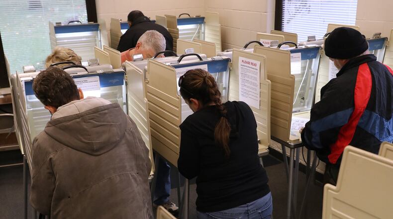 Voters fill out their ballots early at the Clark County Board of Election Friday. BILL LACKEY/STAFF