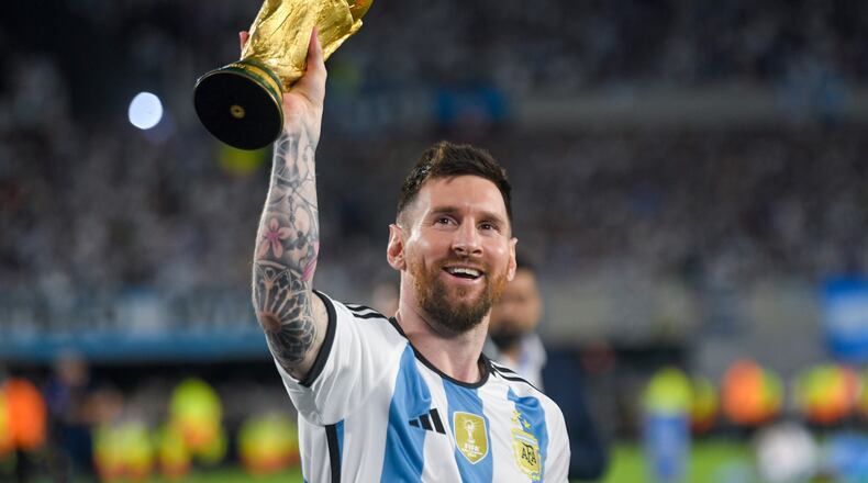 FILE - Argentina's Lionel Messi hoists the winning team replica of the FIFA World Cup trophy during a celebration ceremony for local fans after an international friendly soccer match against Panama at the Monumental stadium in Buenos Aires, Argentina, March 23, 2023. (AP Photo/Gustavo Garello, file)