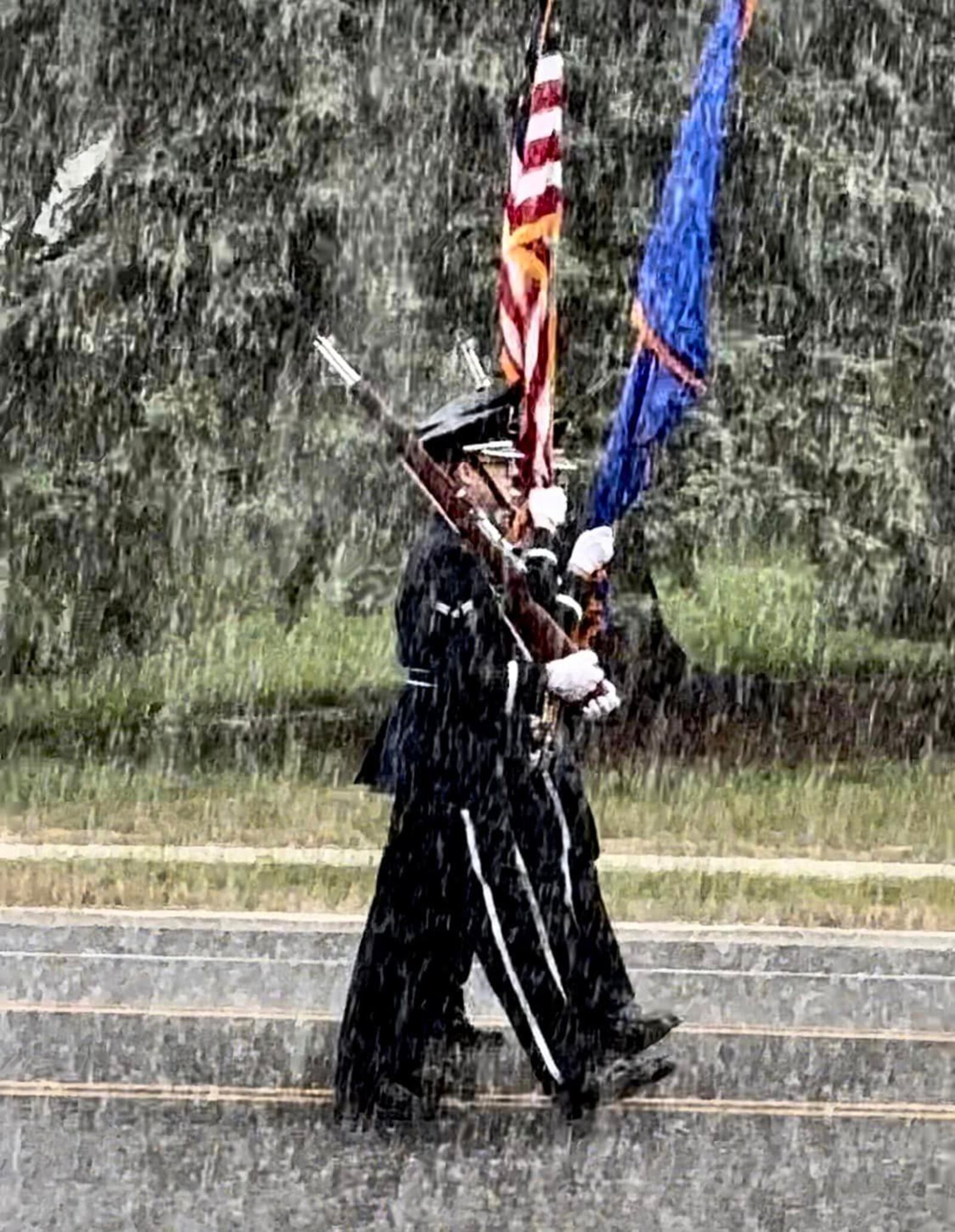 Ignoring the downpour, the Honor Guard from Wright Patterson Air Force Base led the 2024 Enon Independence Day Parade. Photo by Denise Bockleman